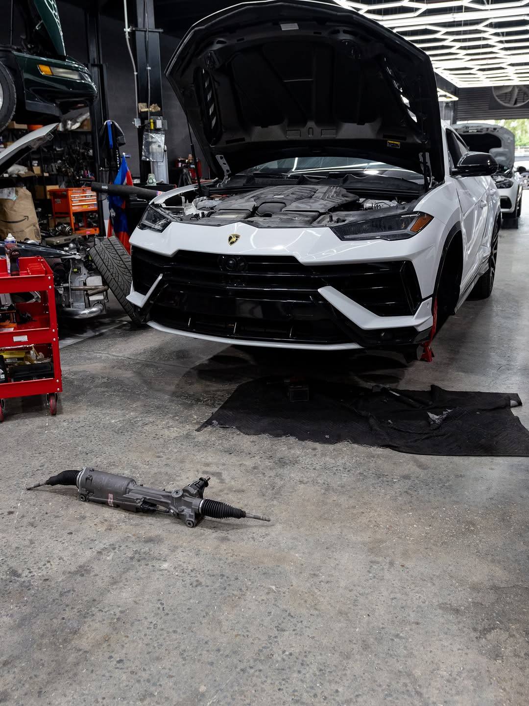 White Lamborghini Urus with steering rack removed